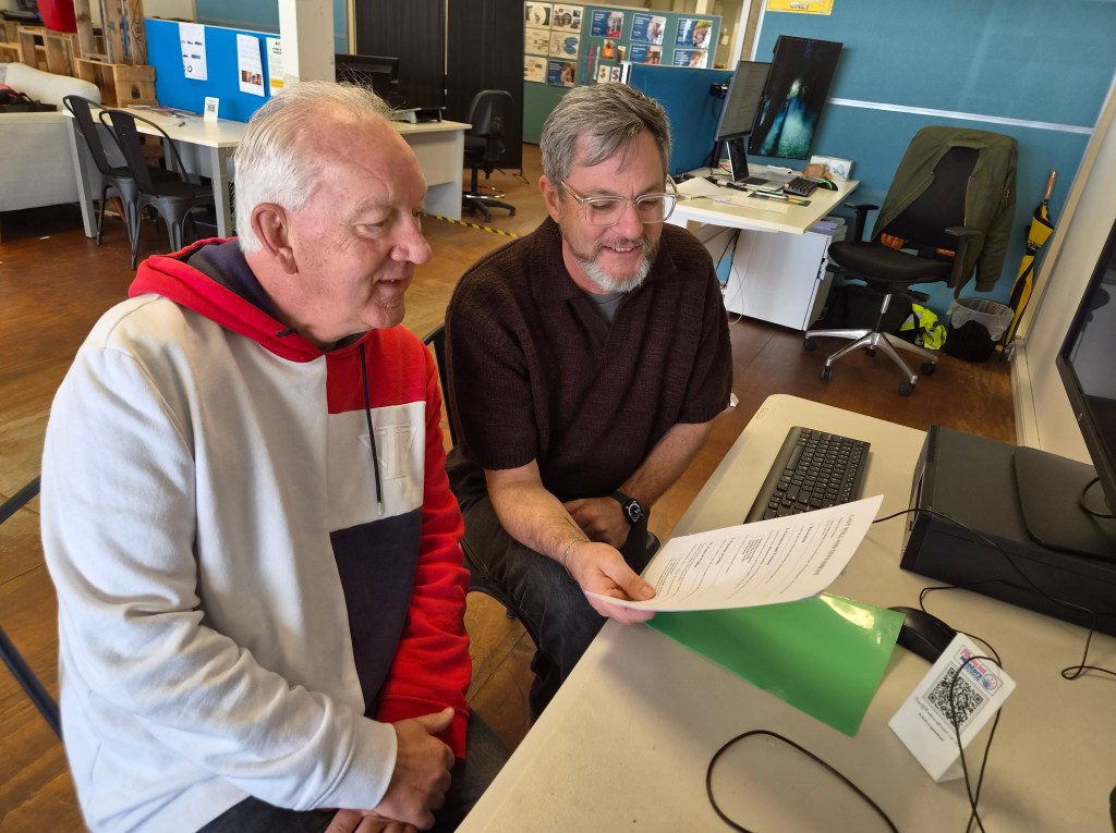 Scott and Barry, Advocates for the Free Public Advocacy Service and The Hub Te Puke look at a Community Will.